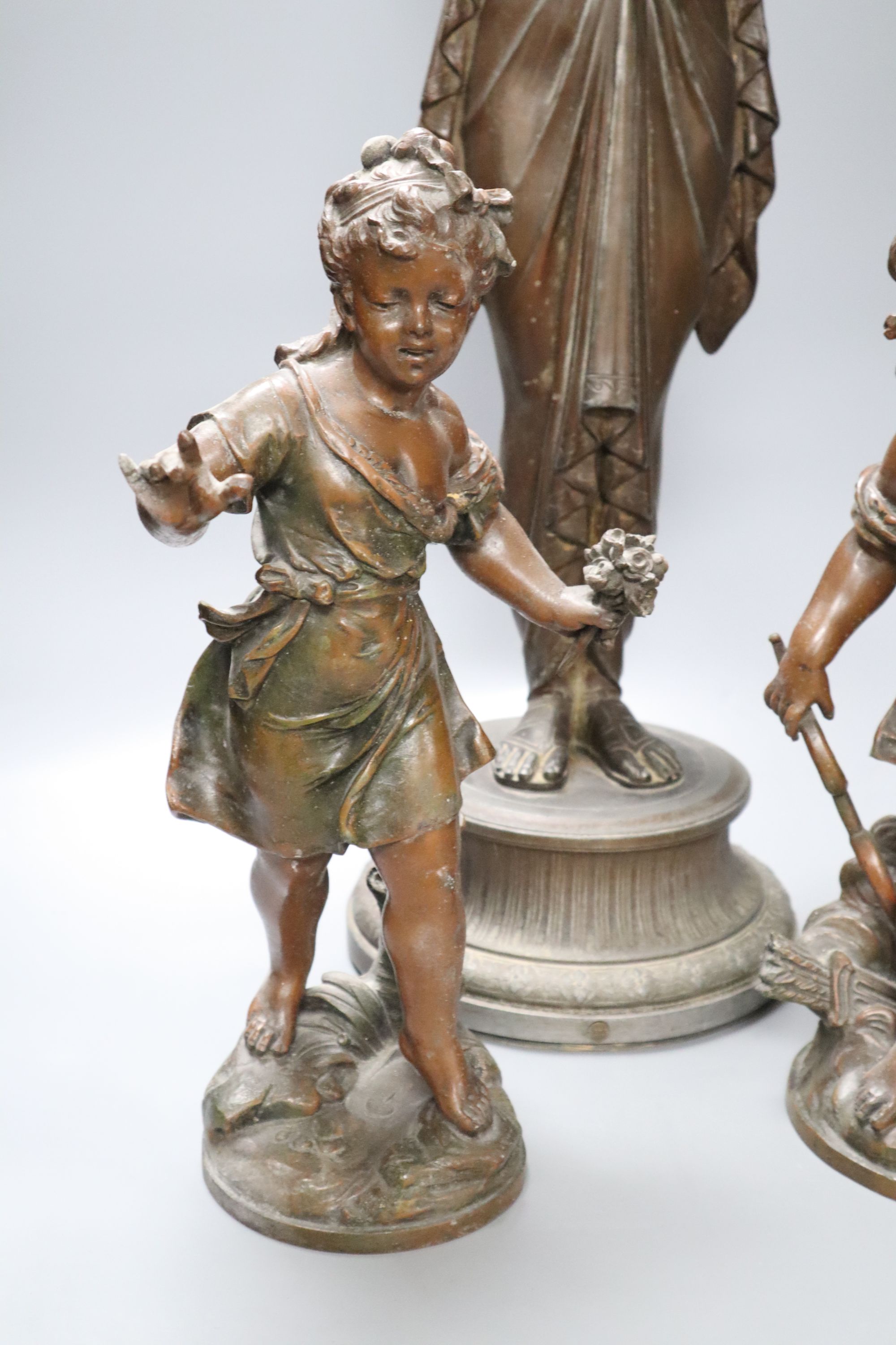 A pair of spelter cherubs, after Bruchon, and another spelter figure, height 74cm